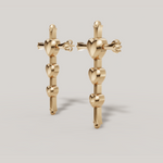 Load image into Gallery viewer, Gold heart-shaped earrings on a light gray background