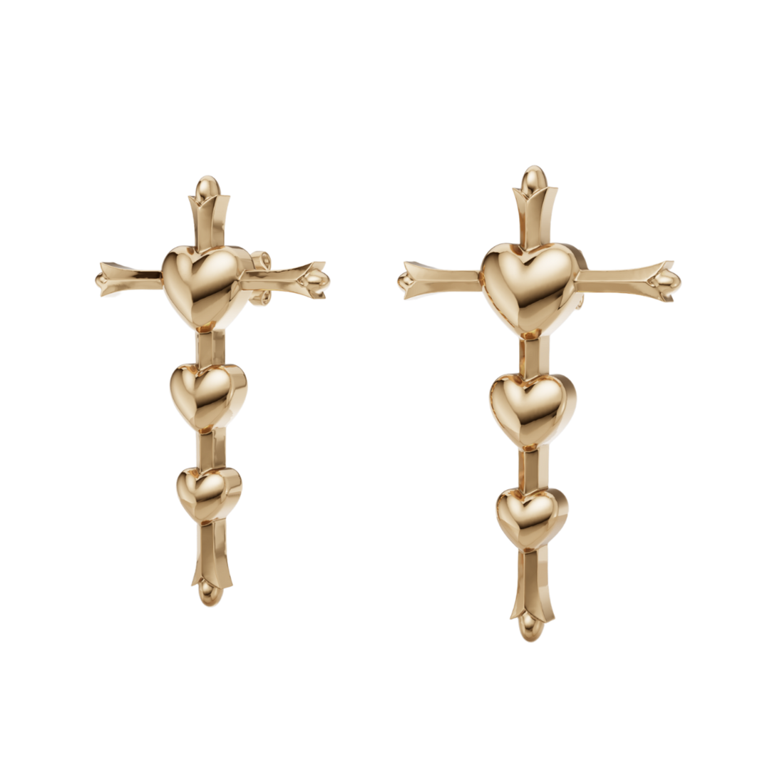 Gold cross and heart earrings on a white background